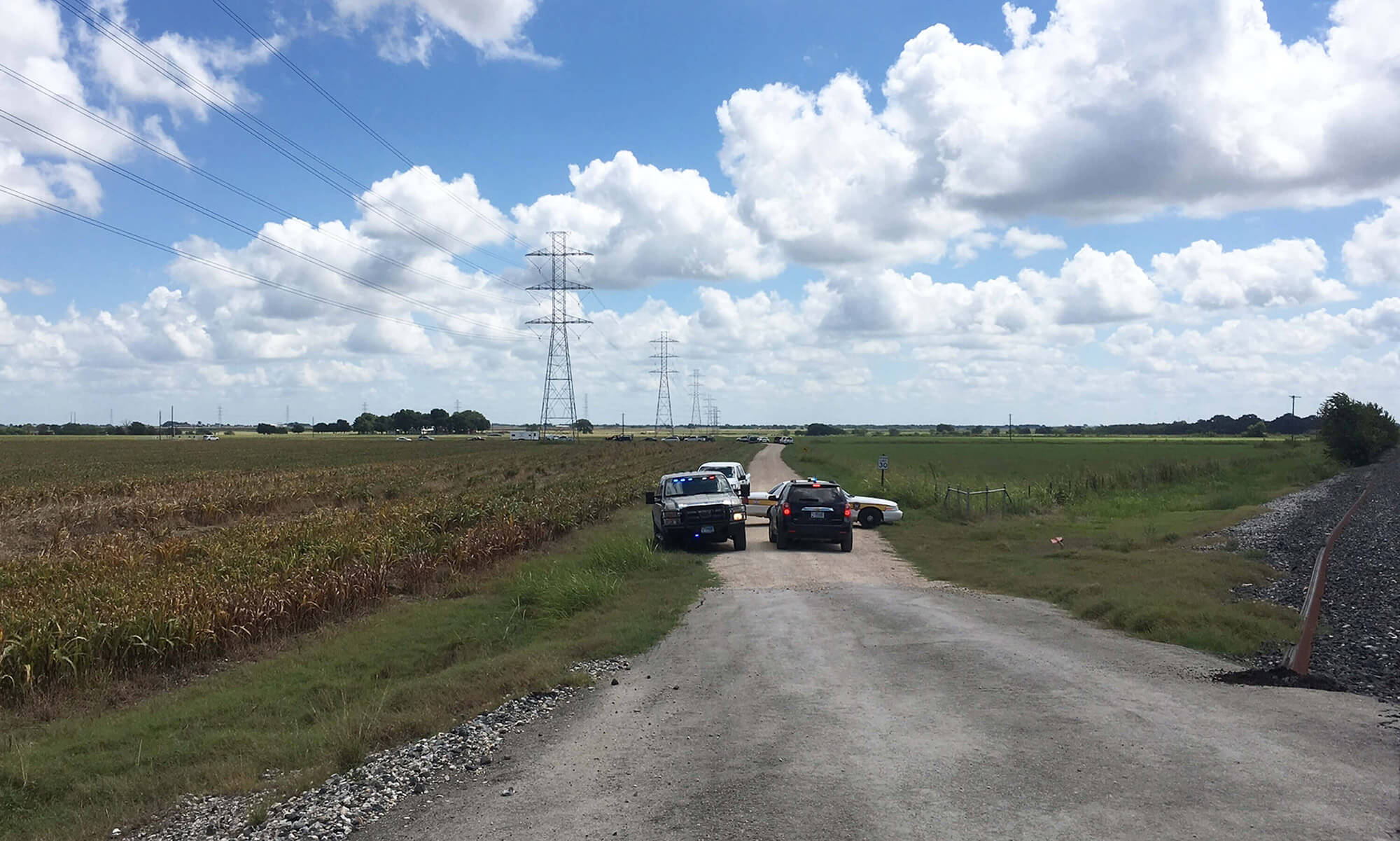 Image of police cars blocking the road to the crash site