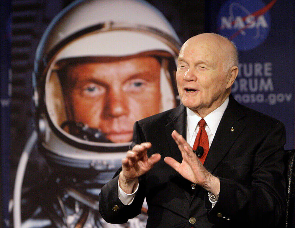 Image of John Glenn speaking to astronauts