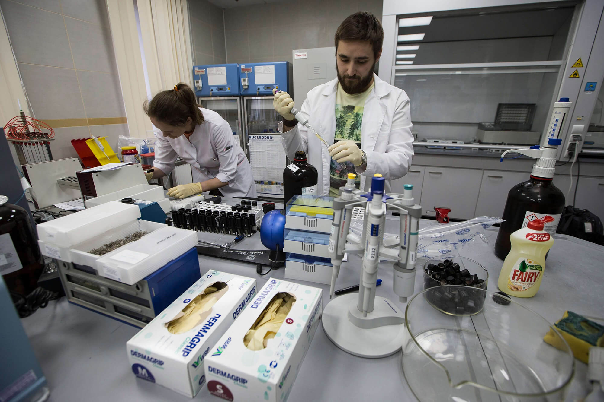 Image of two scientists in white coats in laboratory.