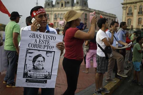 Protestor Holds a Sign Reading "Have You Seen This Crook?"