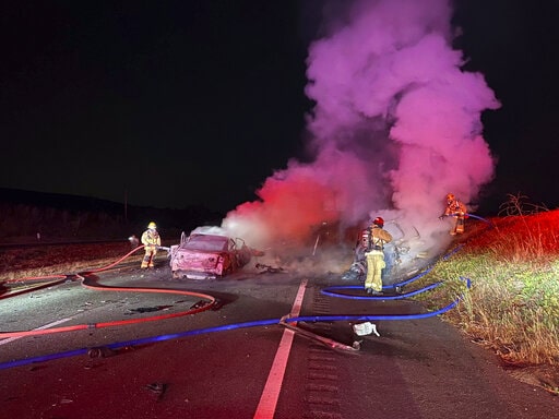 California wildfires with firefighters on a road