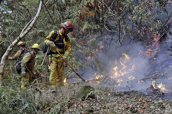 Firefighters attempt to contain the fire