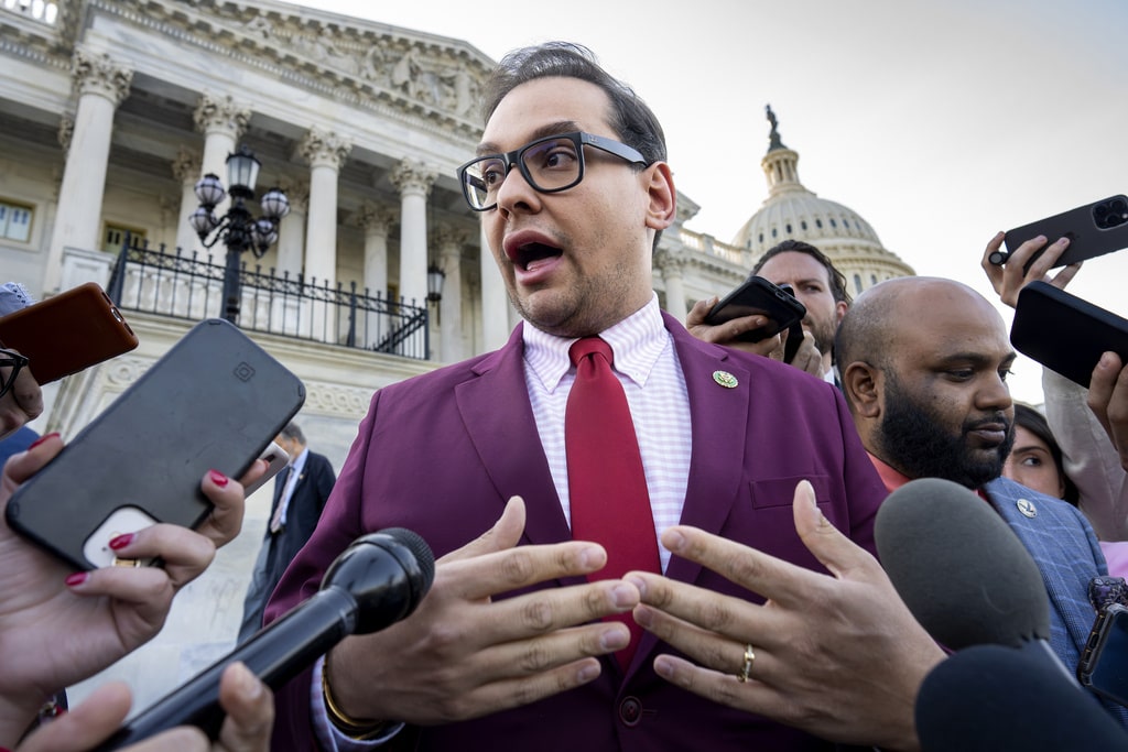 Rep. George Santos, R-N.Y., speaks to reporters outside after an effort to expel him from the House, at the Capitol in Washington.