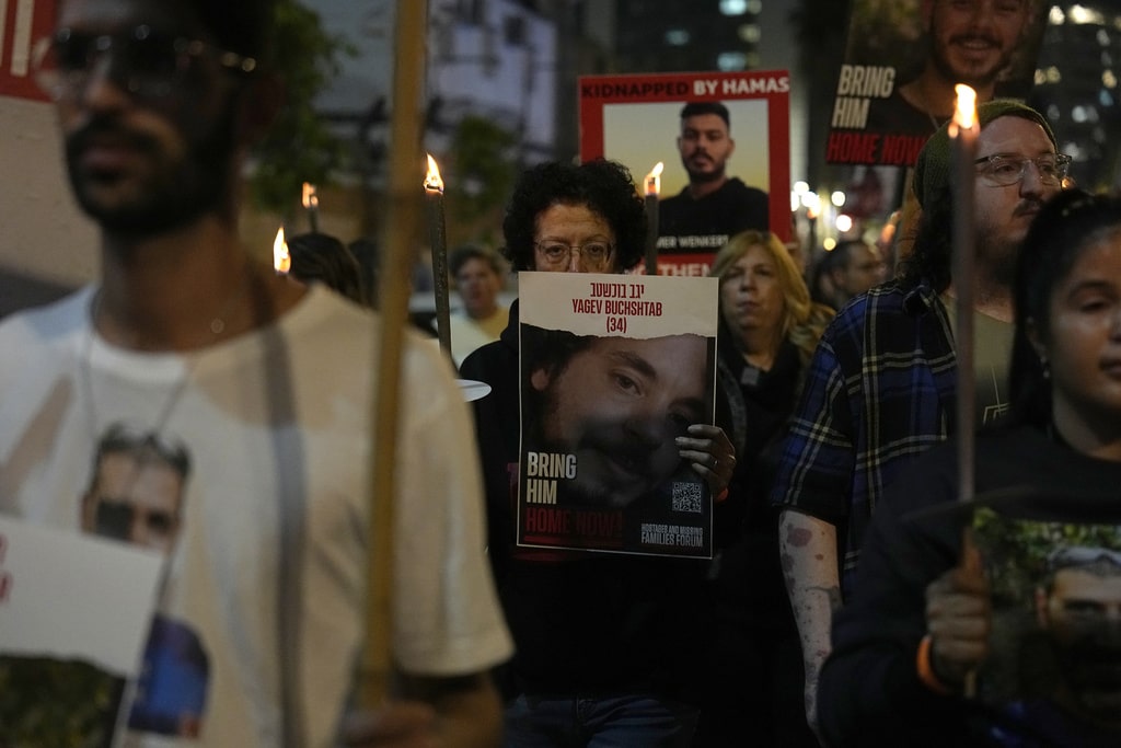 Relatives and friends of hostages held in the Gaza Strip by the Hamas militant group call for their release during the Jewish holiday of Hanukkah in the Hostages Square at the Museum of Art in Tel Aviv, Israel, Thursday, Dec. 7, 2023.