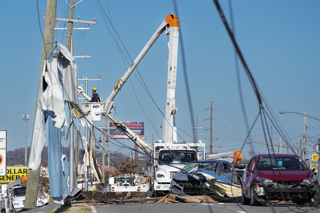 Construction crews work to repair power lines Monday, Dec. 11, 2023 in Nashville, Tenn. Central Tennessee residents and emergency workers are continuing the cleanup from severe storms and tornadoes that hit the area.