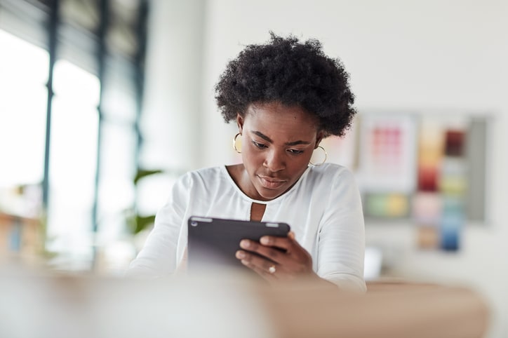 Creative black woman with a tablet