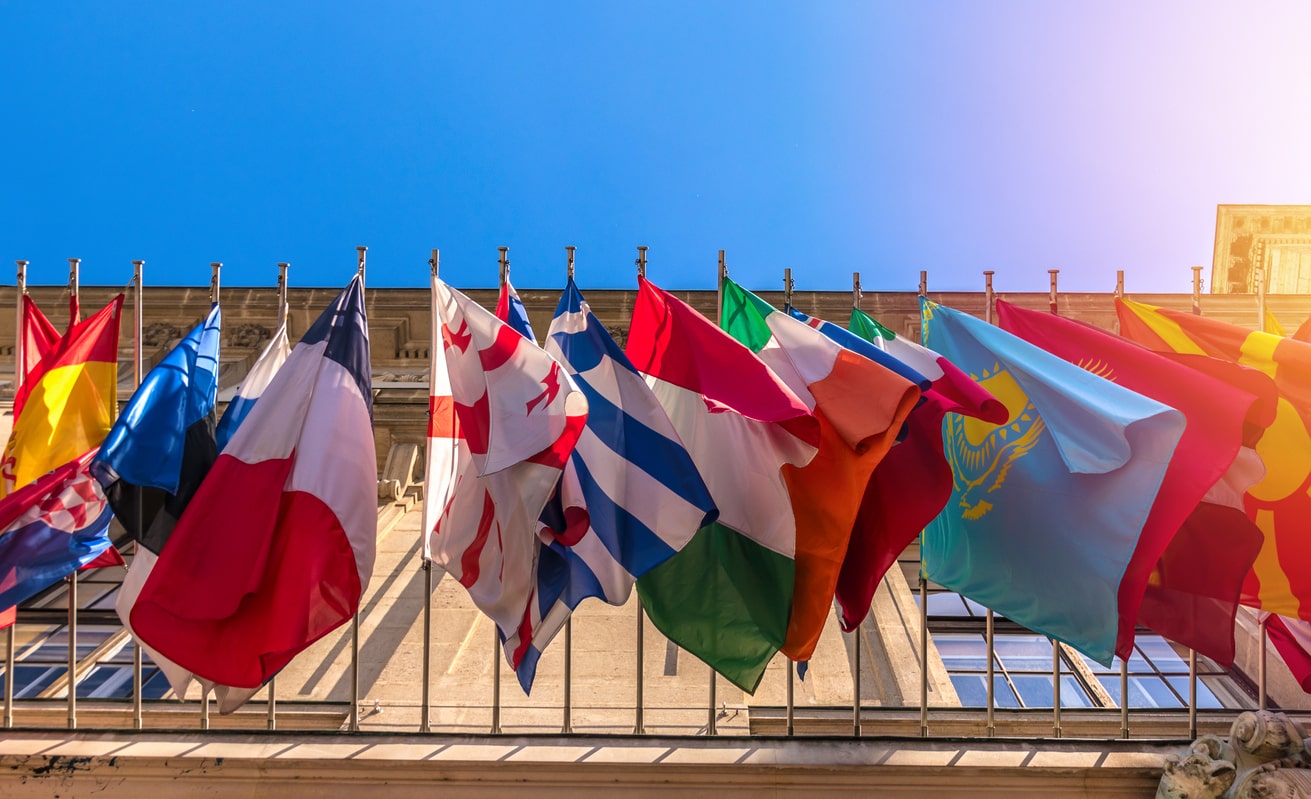 Flags of different countries hang above embassy building