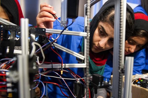 Afghan robotics team members construct their robot. 